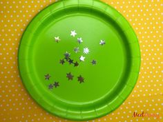 a green paper plate with silver stars on it