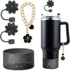 a black travel mug with gold chain, bracelets and flower charms on the side