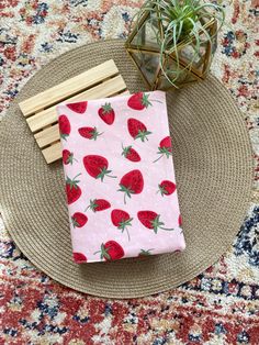 strawberries on pink background with wooden sticks and air plant