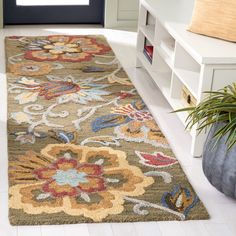 an area rug with flowers on it in front of a door