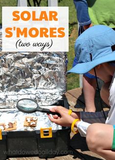 two people looking at some food in a box with the words solar s'mores on it