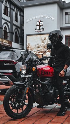 a man wearing a helmet sitting on a motorcycle