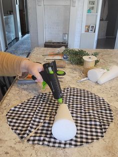 a person using a blow dryer on a counter top