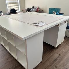 a large white desk with lots of shelves on it