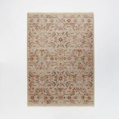 a beige and red area rug with an intricate design on the bottom, in front of a white background