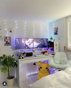 a bedroom with two monitors and a pokemon pikachu stuffed animal