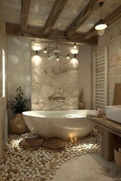 a bath room with a large tub and rocks on the floor