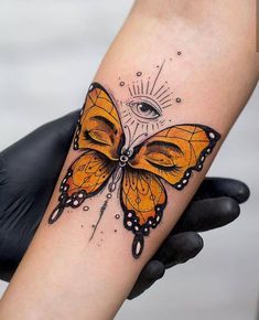 a woman's arm with a butterfly tattoo on it