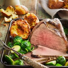 roast beef and vegetables on a tray with bread