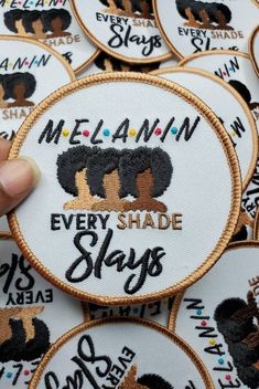 someone is holding up some embroidered patches with dogs on them and the words melanin every shade stays