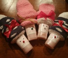 five baby mittens and one cup are sitting on the table