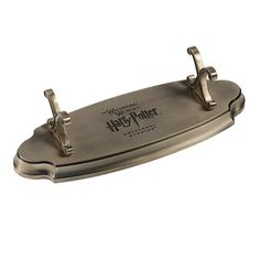 a harry potter metal tray with handles and two clips on the handle, sitting on a white background