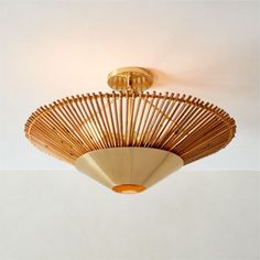 a ceiling light that is made out of wood and has a fan on the top