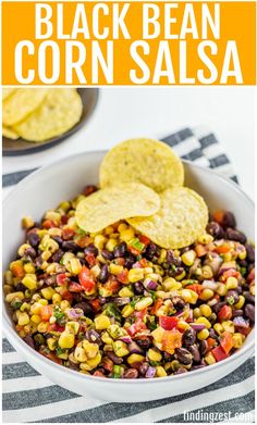 black bean corn salsa in a white bowl with tortilla chips on the side