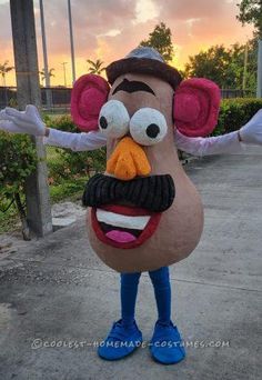 a man in a costume made to look like a cartoon character standing on the sidewalk