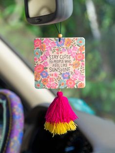 a sign hanging from the dashboard of a car that says stay close to people who are sunshine