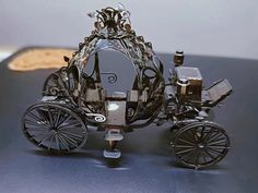 an intricately designed carriage sits on a table