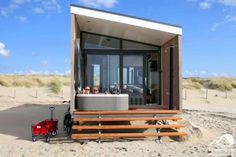 an outdoor hot tub in the sand with people sitting inside