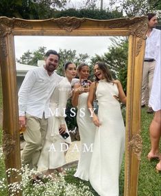 a group of people standing in front of a mirror with the words miss y'adam on it