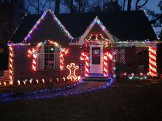 a house decorated with christmas lights and candy canes