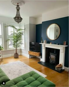 a living room filled with furniture and a fire place in front of a mirror on the wall