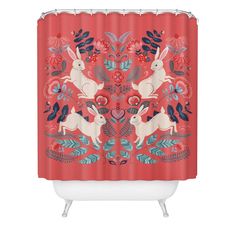 a red shower curtain with rabbits and flowers