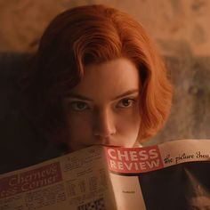 a woman with red hair reading a book