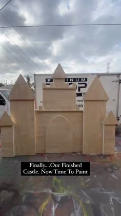 a cardboard castle with the words finally our finished castle now time to paint on it