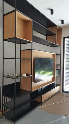 an entertainment center with shelving unit and sliding glass doors