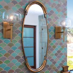 a bathroom with a large mirror and two lights on the wall next to each other