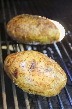 two potatoes cooking on top of an open grill