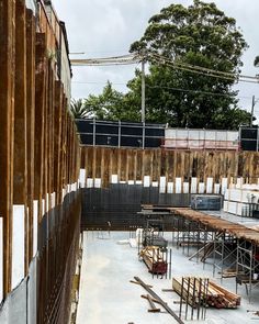 an unfinished building with scaffolding on the side and wooden slats around it