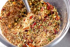 a glass bowl filled with spices and seasoning