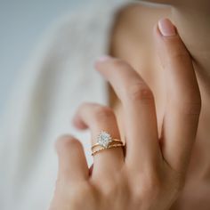 a woman's hand with a diamond ring on it