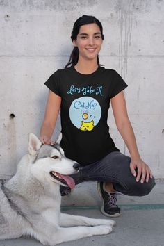 a woman sitting on the ground next to a husky dog with its tongue hanging out