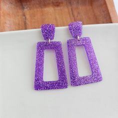 Get ready to bring the glam to your game day style with the Avery. These statement earrings are sure to make a bold statement and add a touch of sparkle to your look. Hypoallergenic stainless steel posts 20mm stud size Lightweight and durable glitter acetate acrylic Studded Necklace, Glitter Earrings, Digital Gift Card, Digital Gifts, Purple Glitter, Claw Clip, Gift Card Shop, Bridal Hair Accessories, Game Day