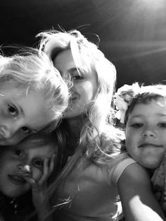 a group of women and two children posing for a photo together in black and white