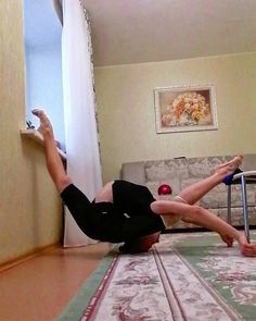 a woman is laying on the floor with her legs spread out and feet in the air