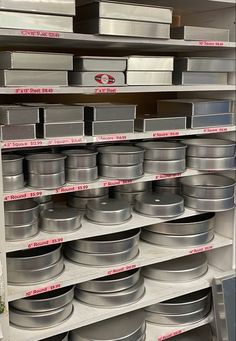 the shelves are filled with many different types of containers and pans for sale on them