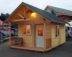 a small wooden cabin sitting on top of a parking lot