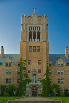 a large building with a clock on the front and side of it's tower