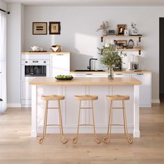 two stools sit at the center of a kitchen island