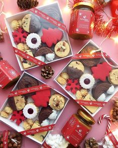 christmas cookies and nuts are arranged on a pink surface