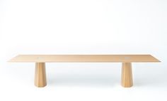 a wooden table sitting on top of a white floor