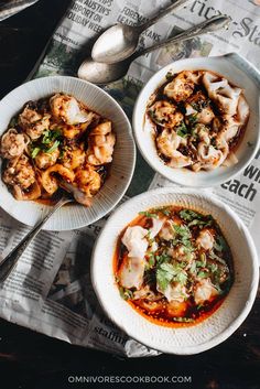 three white bowls filled with food on top of a newspaper next to spoons and utensils