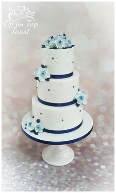 a three tiered cake with blue flowers on top