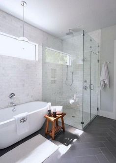 a white bath tub sitting next to a walk in shower