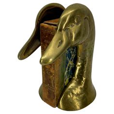 an elephant head is placed in the shape of a bookend with books on it