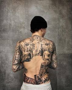 a man with many tattoos on his back