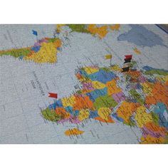 a cross stitch map of the world with pins in it's countries and major cities